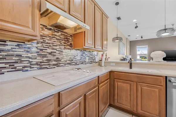 a kitchen with sink cabinets and a window