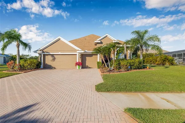 a view of a white house with a yard