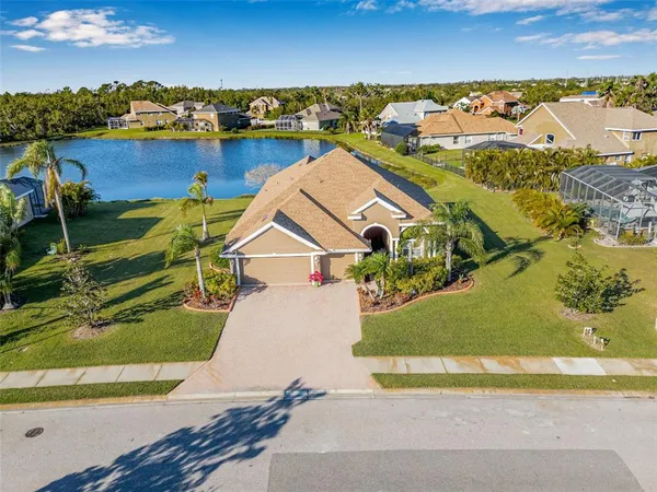 an aerial view of a house with a ocean view