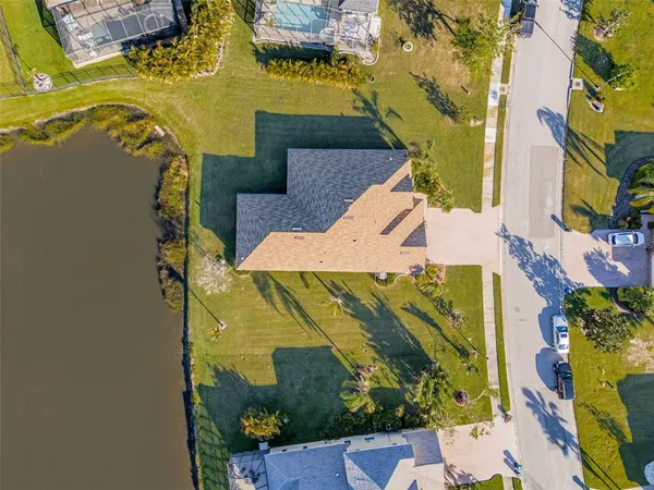 an aerial view of a houses with swimming pool