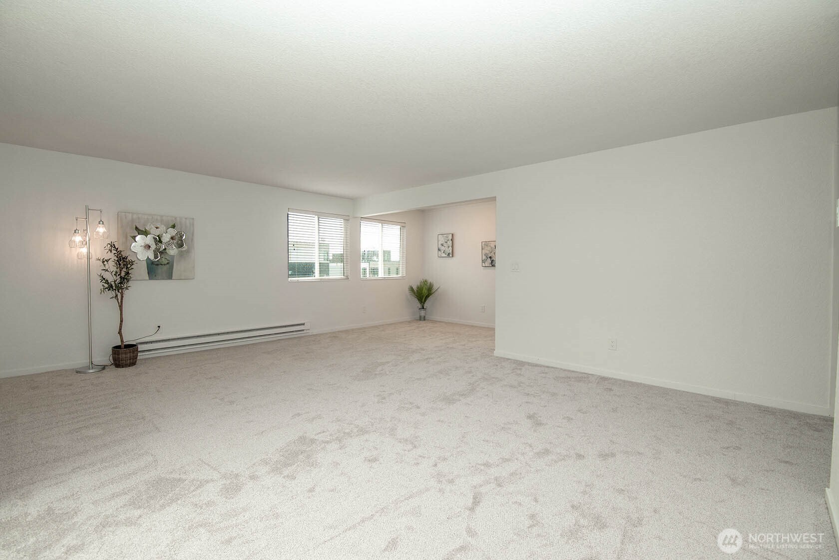 8747 Phinney Avenue North, Unit 13 Seattle, WA 98103 - Photo 14 of 32 an empty room with chandelier fan and windows