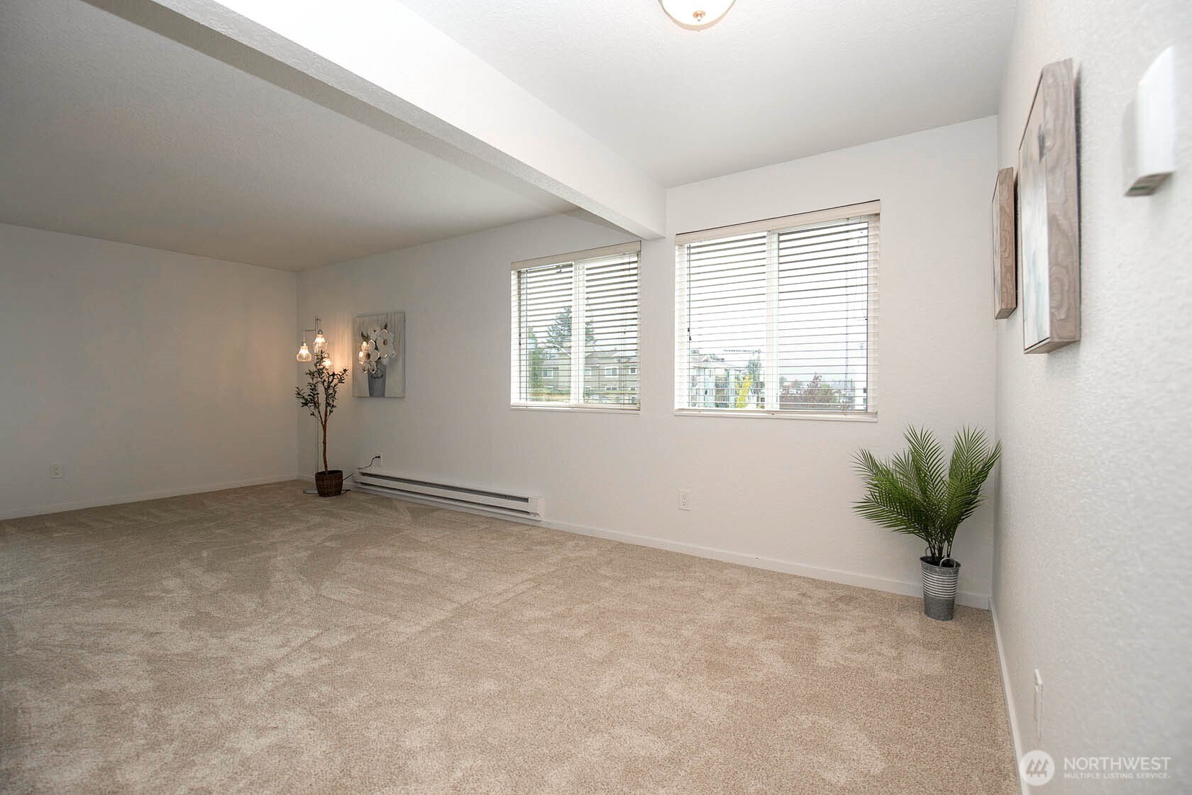 8747 Phinney Avenue North, Unit 13 Seattle, WA 98103 - Photo 16 of 32 an empty room with windows and flower pot