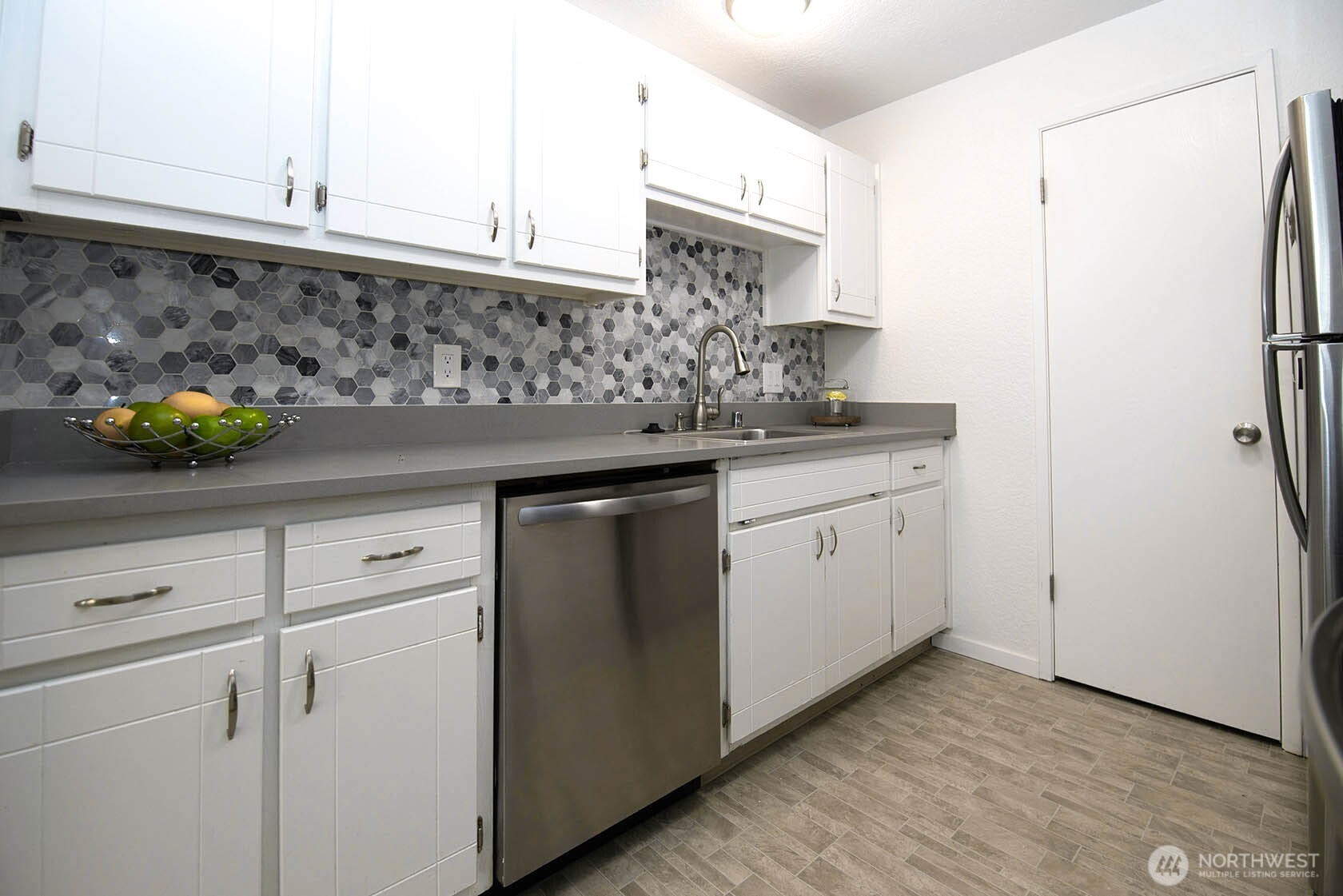8747 Phinney Avenue North, Unit 13 Seattle, WA 98103 - Photo 19 of 32 a kitchen with stainless steel appliances a sink and cabinets