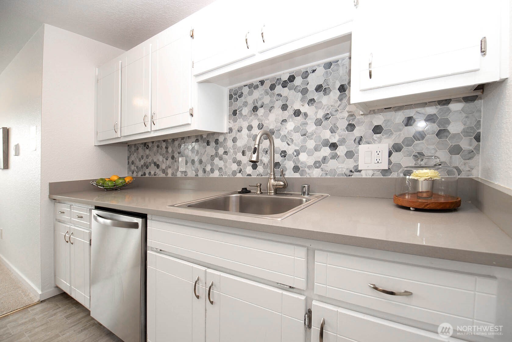 8747 Phinney Avenue North, Unit 13 Seattle, WA 98103 - Photo 23 of 32 a kitchen with a sink and cabinets