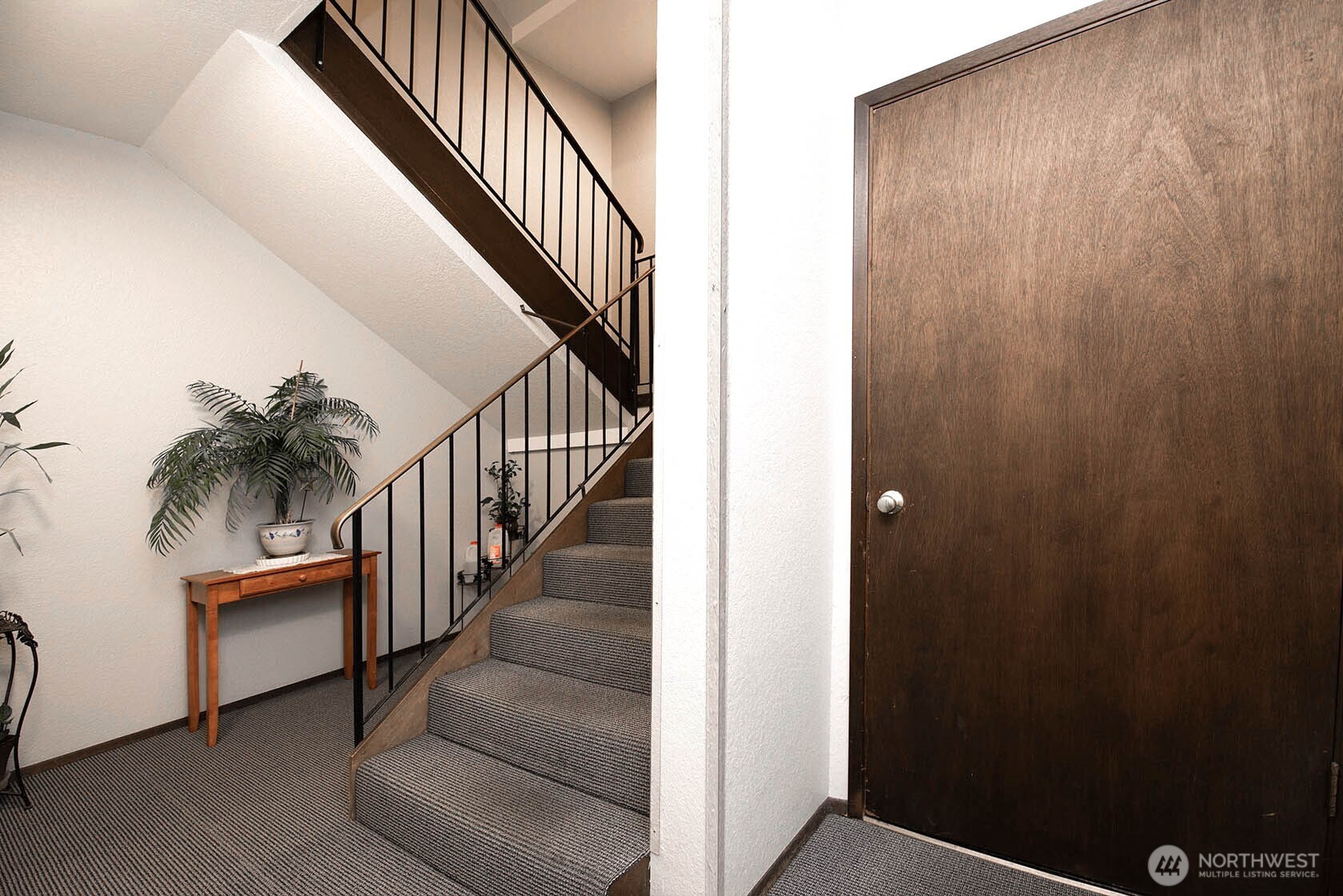 8747 Phinney Avenue North, Unit 13 Seattle, WA 98103 - Photo 29 of 32 a view of staircase with wooden floor and a potted plant