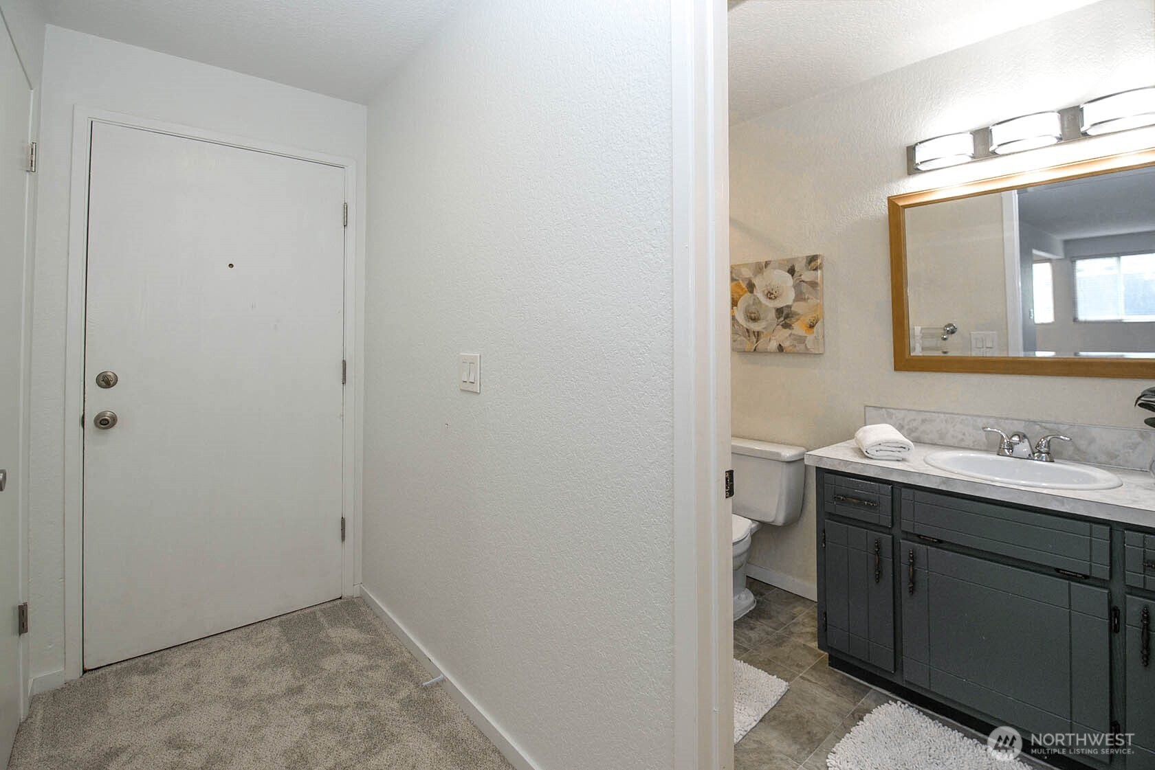 8747 Phinney Avenue North, Unit 13 Seattle, WA 98103 - Photo 3 of 32 a view of bathroom with a sink and mirror