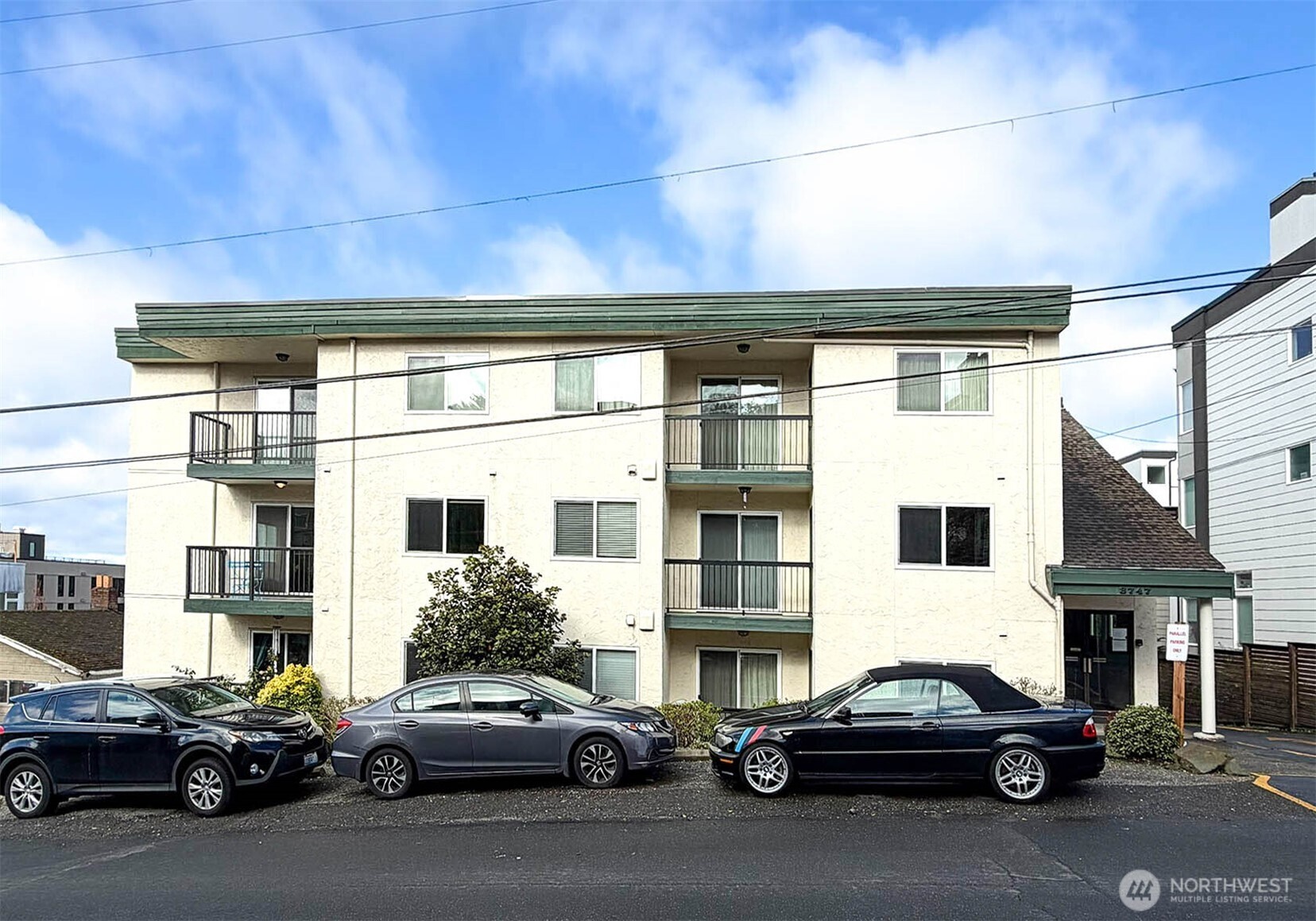 8747 Phinney Avenue North, Unit 13 Seattle, WA 98103 - Photo 31 of 32 a car parked in front of a building