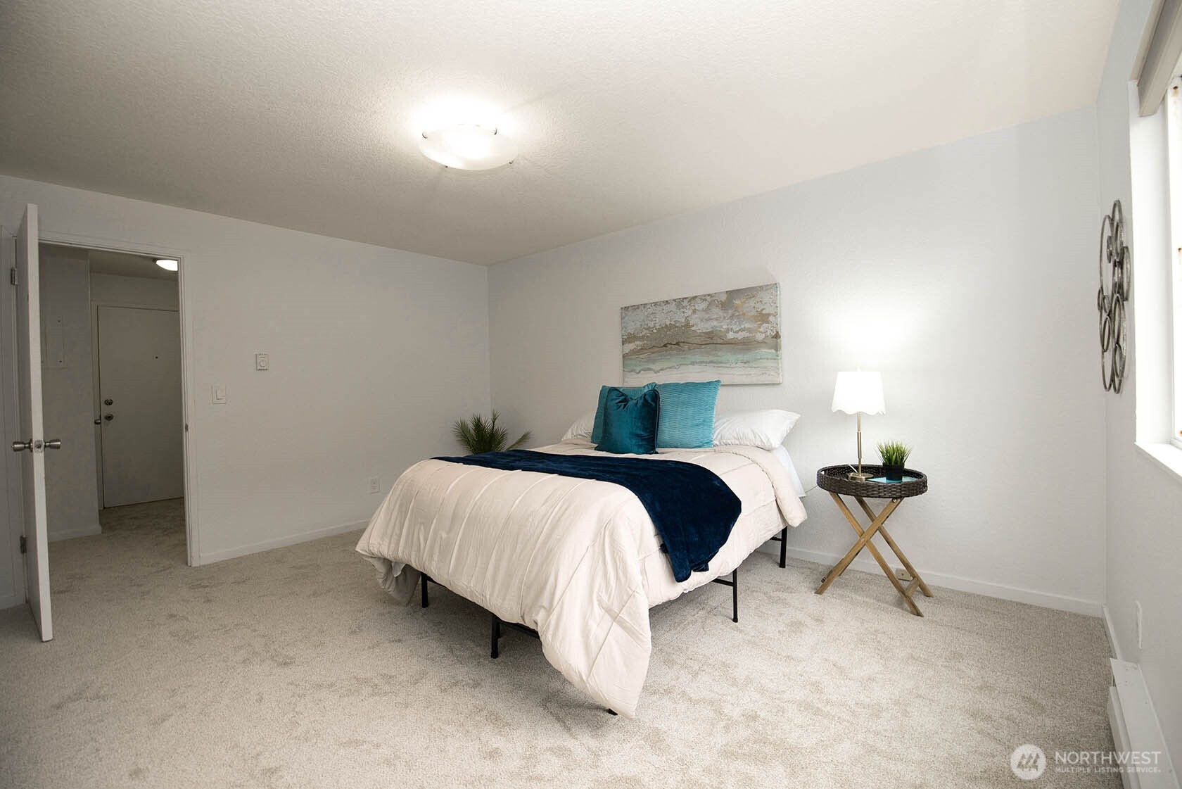 8747 Phinney Avenue North, Unit 13 Seattle, WA 98103 - Photo 8 of 32 a bedroom with a bed and table