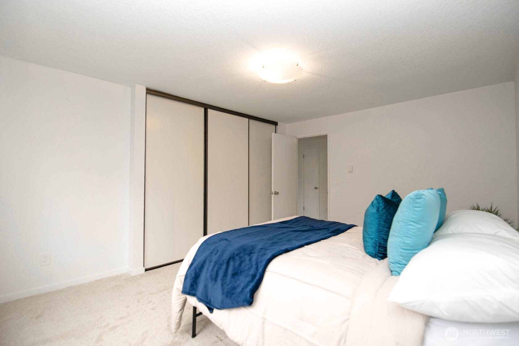 8747 Phinney Avenue North, Unit 13 Seattle, WA 98103 - Photo 9 of 32 a bedroom with a bed and a window