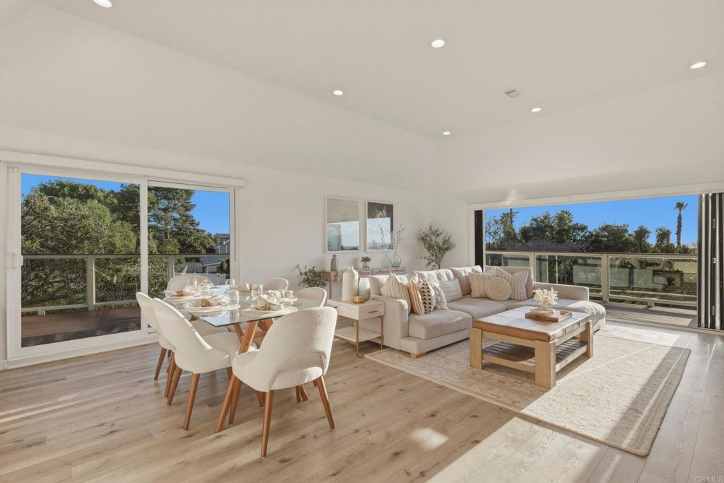 1712 Burgundy Road Encinitas, CA 92024 - Photo 1 of 31 a living room with furniture and a floor to ceiling window
