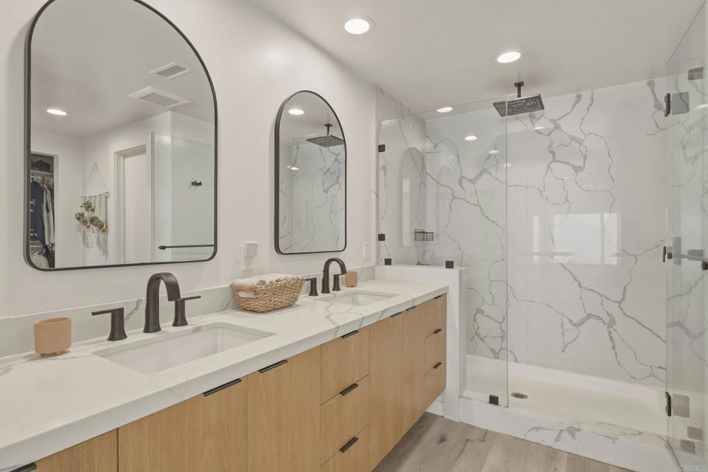 1712 Burgundy Road Encinitas, CA 92024 - Photo 16 of 31 a bathroom with double sink and a mirror