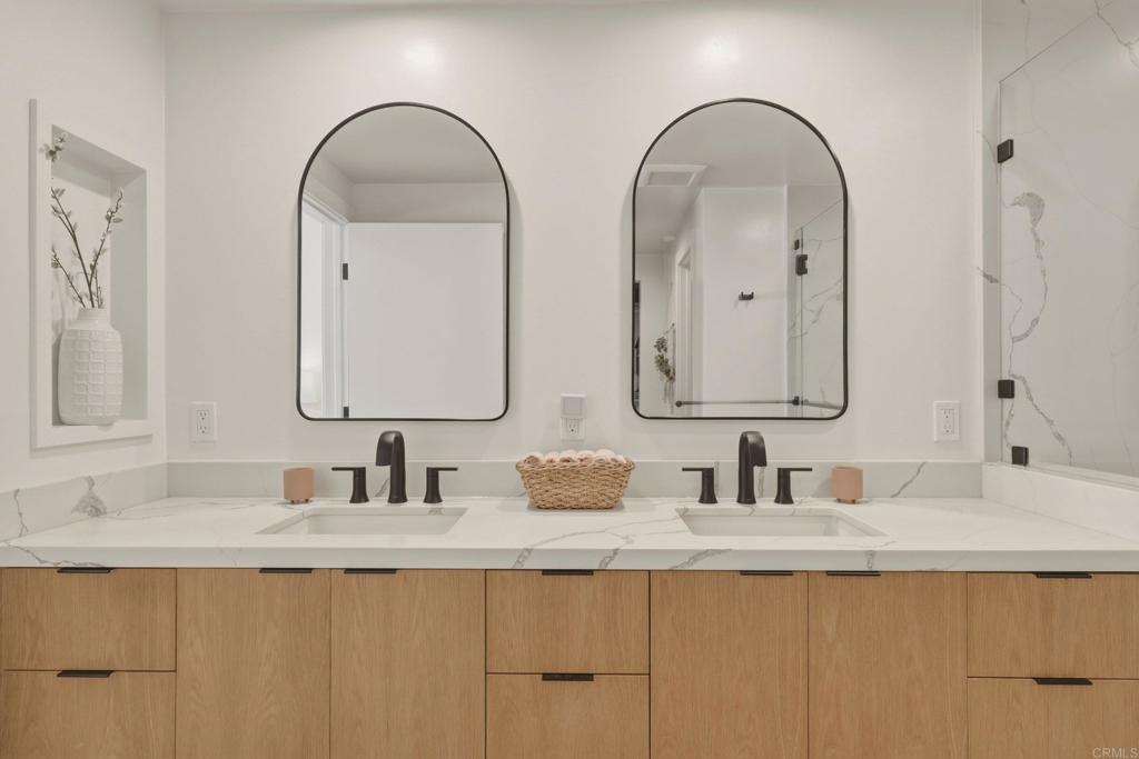 1712 Burgundy Road Encinitas, CA 92024 - Photo 17 of 31 a bathroom with double vanity sinks and two mirror