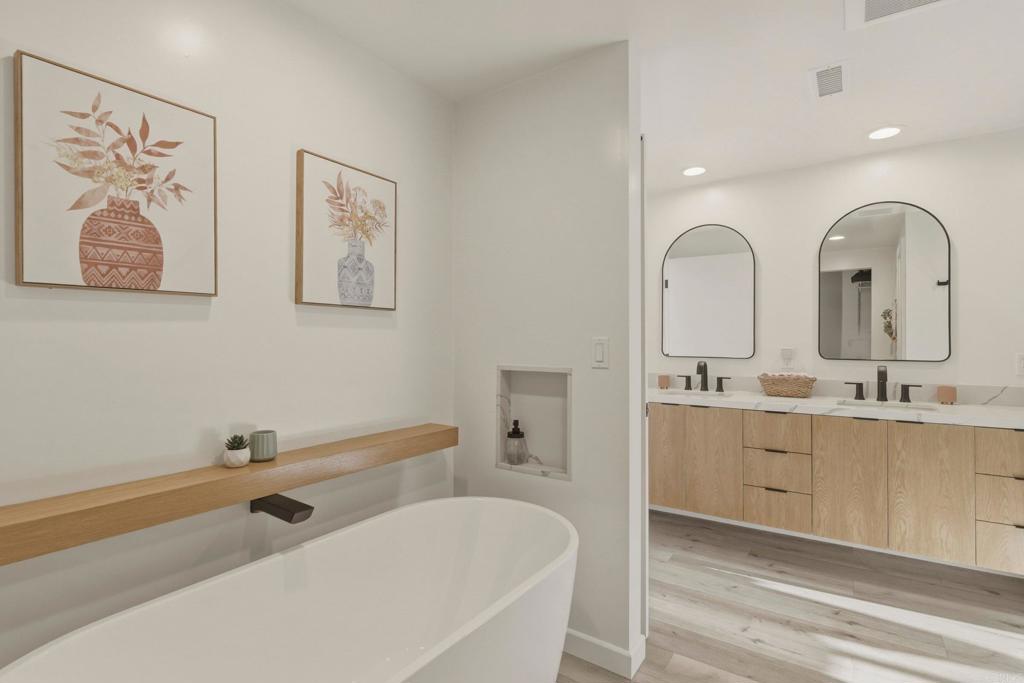 1712 Burgundy Road Encinitas, CA 92024 - Photo 18 of 31 a spacious bathroom with 2 tub sink and a mirror