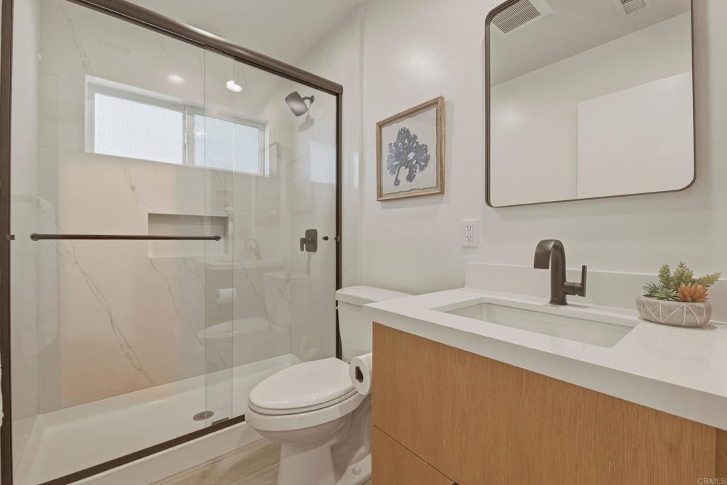 1712 Burgundy Road Encinitas, CA 92024 - Photo 22 of 31 a bathroom with a sink a toilet and shower