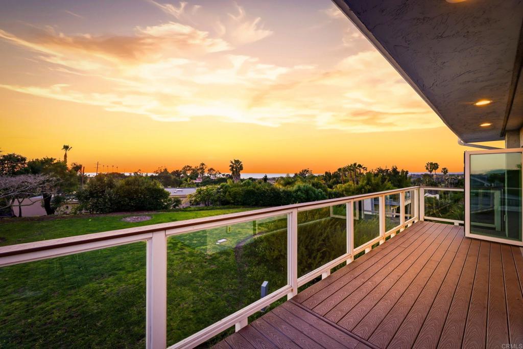 1712 Burgundy Road Encinitas, CA 92024 - Photo 27 of 31 a view of a balcony with wooden floor next to a yard