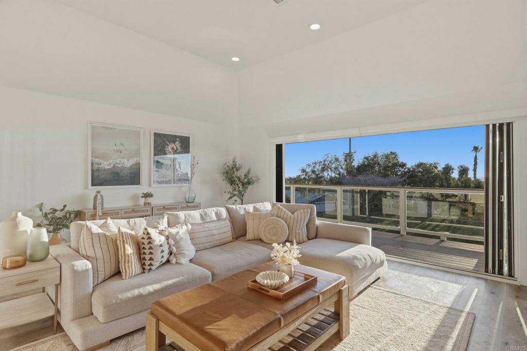1712 Burgundy Road Encinitas, CA 92024 - Photo 4 of 31 a living room with furniture a rug and a table