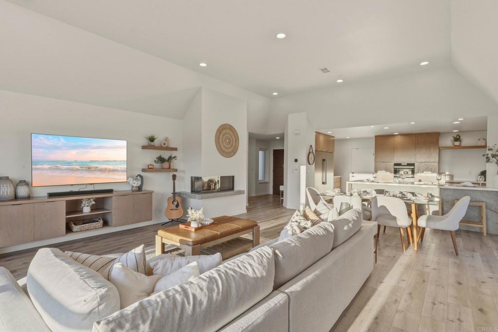 1712 Burgundy Road Encinitas, CA 92024 - Photo 6 of 31 a living room with furniture kitchen view and a flat screen tv