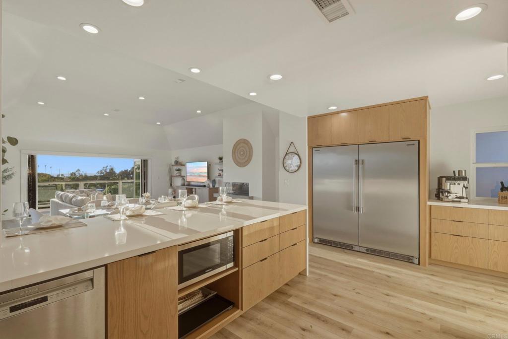 1712 Burgundy Road Encinitas, CA 92024 - Photo 8 of 31 a kitchen with stainless steel appliances granite countertop a sink and a refrigerator