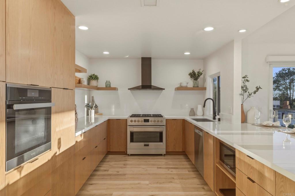 1712 Burgundy Road Encinitas, CA 92024 - Photo 9 of 31 a kitchen with stainless steel appliances granite countertop a sink a stove and a refrigerator
