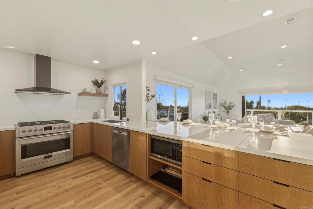 1712 Burgundy Road Encinitas, CA 92024 - Photo 10 of 31 a kitchen with kitchen island granite countertop a sink counter top space stainless steel appliances and cabinets