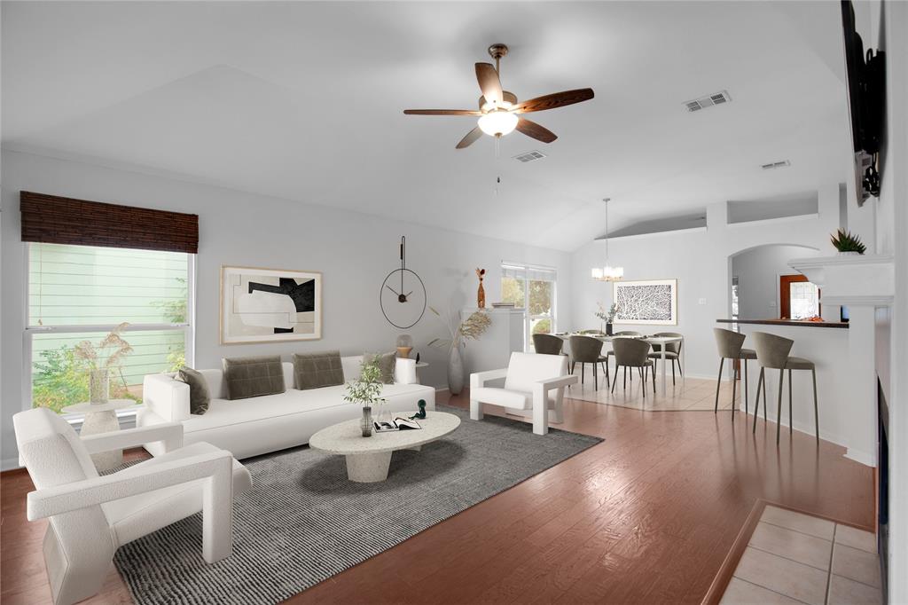 281 Hutton Kyle, TX 78640 - Photo 5 of 37 Natural light cascades across a spacious open-concept living area with lustrous hardwood floors.