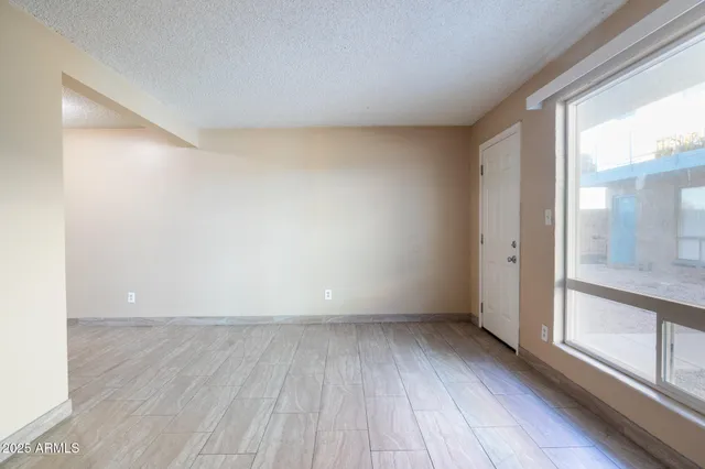 a view of room with window and wooden floor