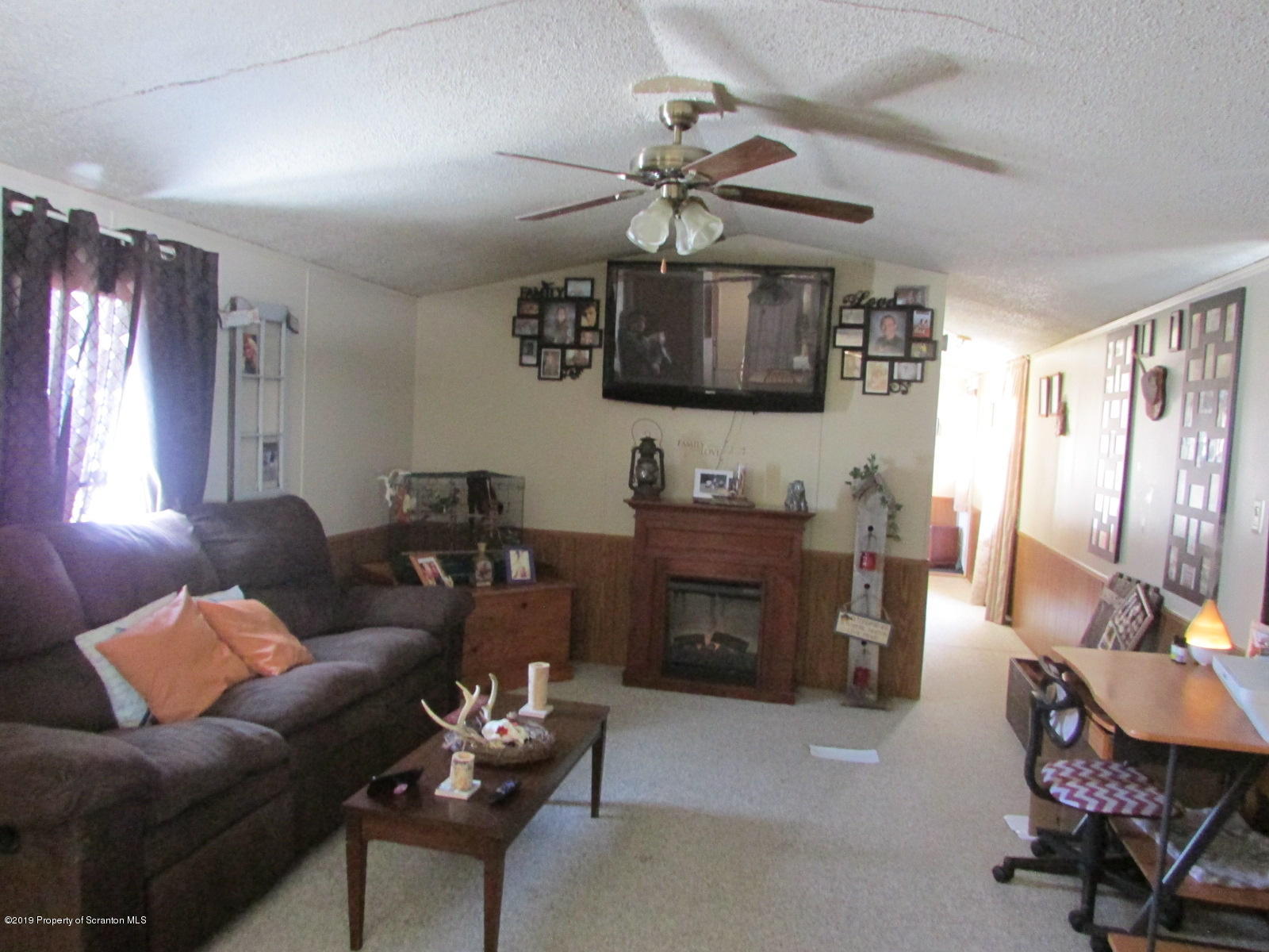 636 State Rte 3021 Springville, PA 18844 - Photo 7 of 16 a living room with furniture a flat screen tv and kitchen view