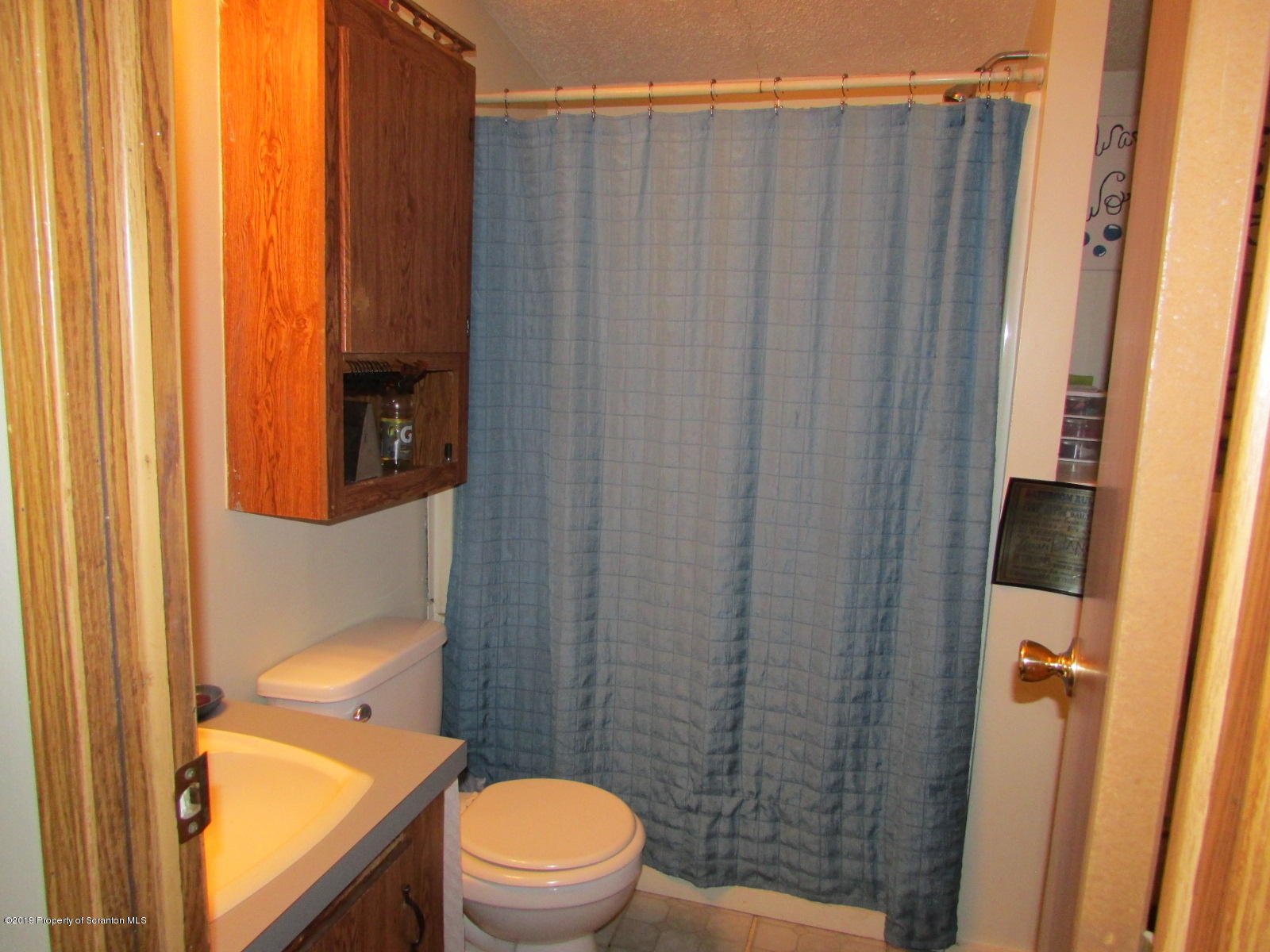 636 State Rte 3021 Springville, PA 18844 - Photo 9 of 16 a bathroom with a toilet and a shower curtain