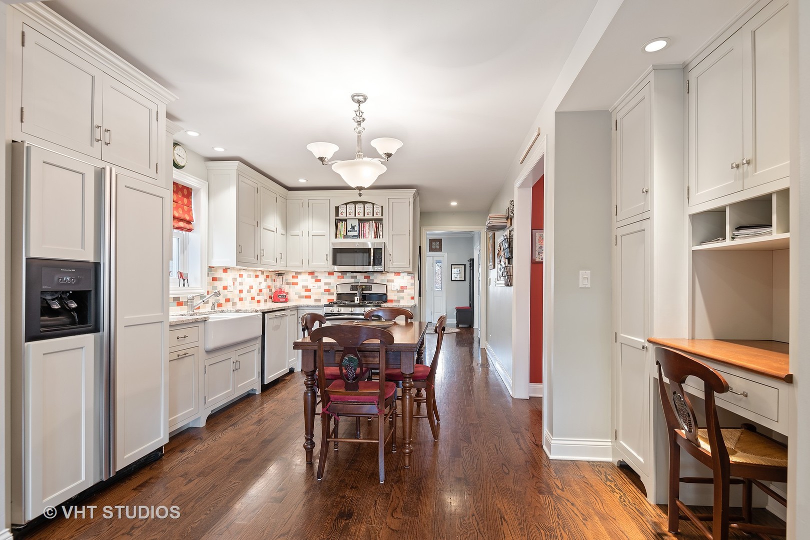 339 Maple Avenue Wilmette, IL 60091 - Photo 8 of 33 a kitchen with stainless steel appliances kitchen island granite countertop a refrigerator a stove a dining table and chairs with wooden floor