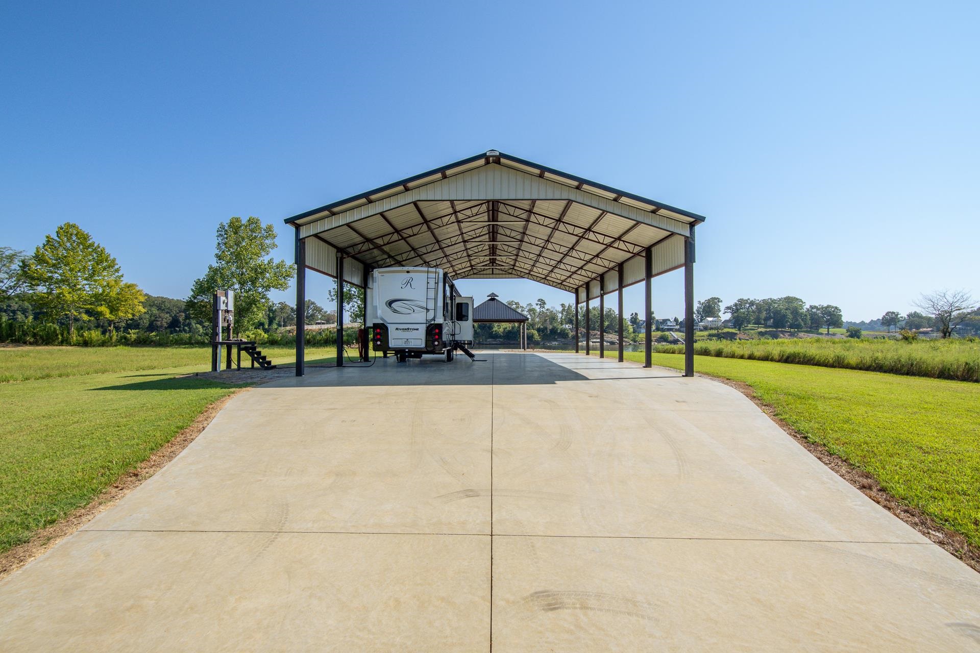 6235 Cravens Road Savannah, TN 38372 - Photo 7 of 11 a view of a patio with a table and chairs under an umbrella