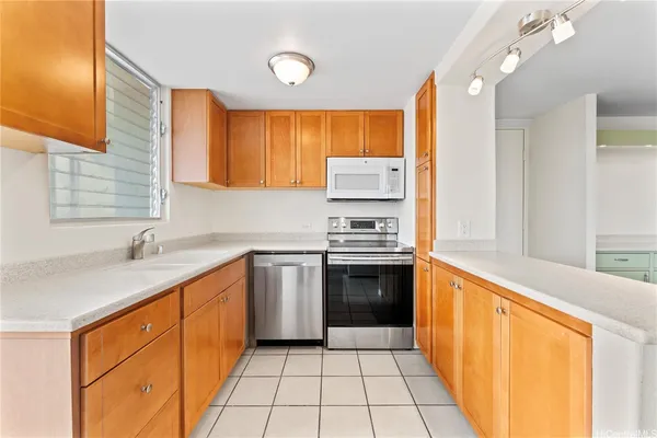 a kitchen with a sink stove top oven and cabinets
