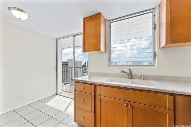 a kitchen with a sink cabinets and window
