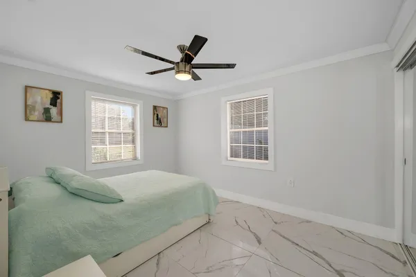 a bedroom with a bed and a window