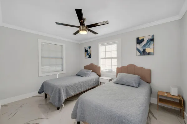 a bedroom with two beds and a window