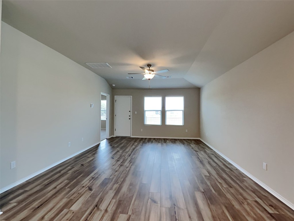5300 Gallop Lane Georgetown, TX 78626 - Photo 2 of 15 a view of an empty room with wooden floor and a window