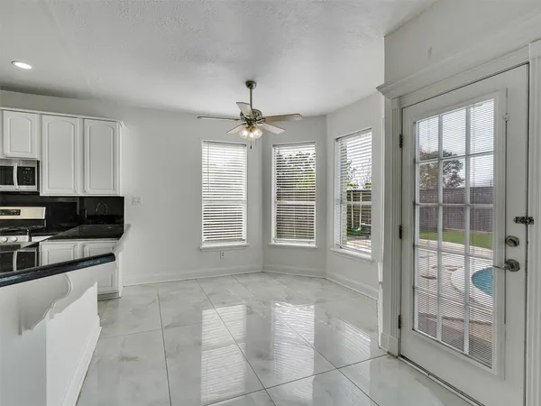 a open kitchen with cabinets and stainless steel appliances