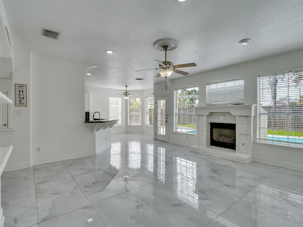 a view of a livingroom with a fireplace and window