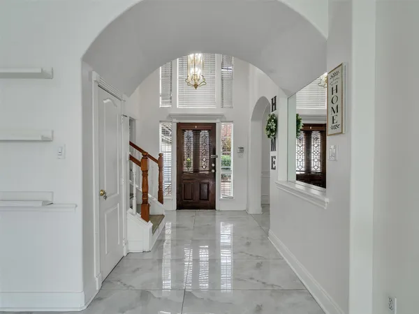a view of a hallway with wooden shelves