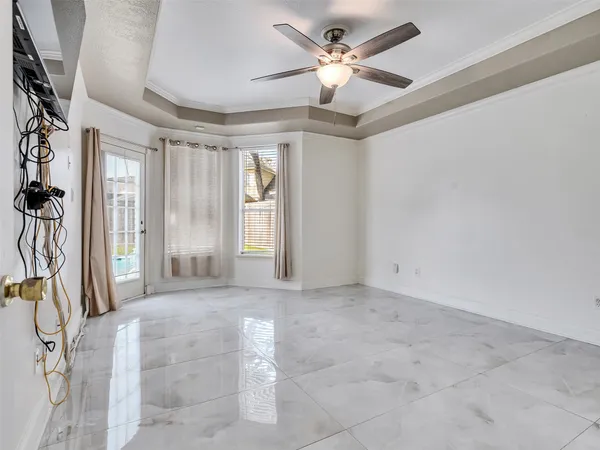 a view of a livingroom with a chandelier furniture and a ceiling fan