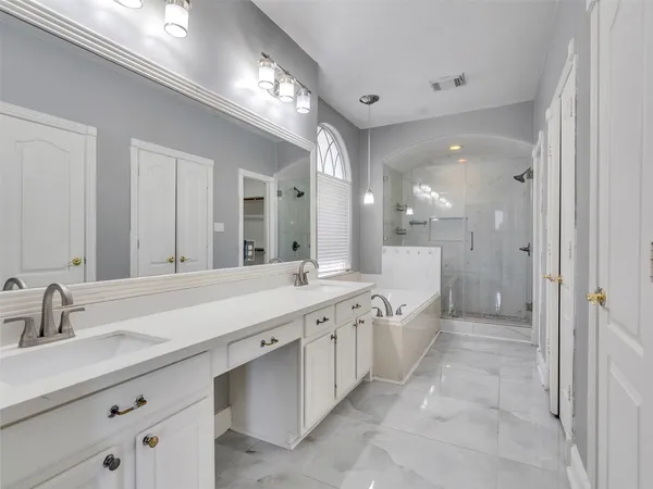 a large bathroom with a double vanity sink and a mirror