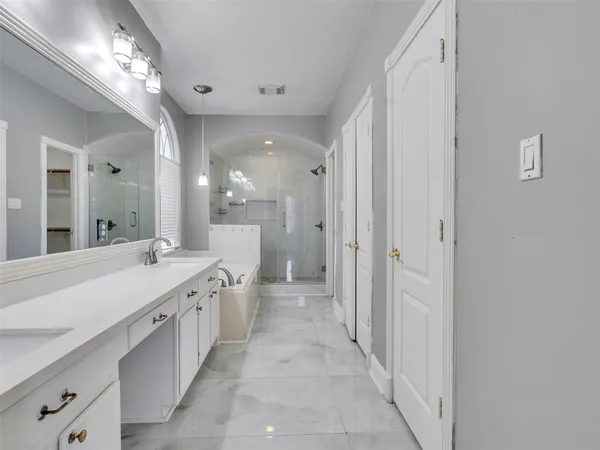 a large bathroom with a double vanity sink and a mirror