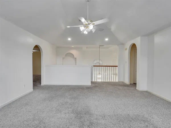 a view of a livingroom with a ceiling fan and window
