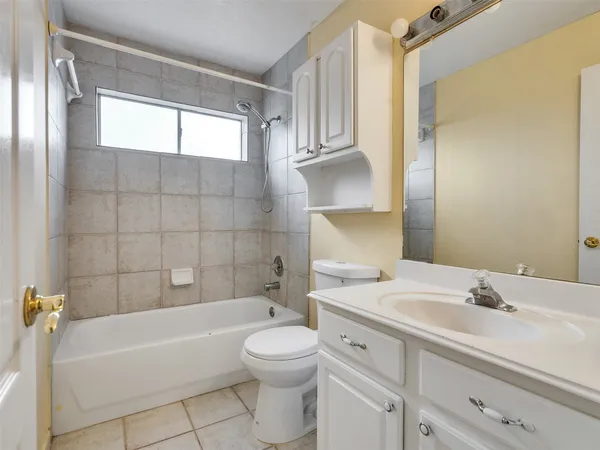 a bathroom with a sink a toilet and bathtub