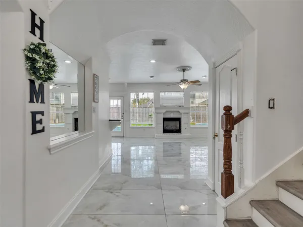 a view of a hallway with a living room