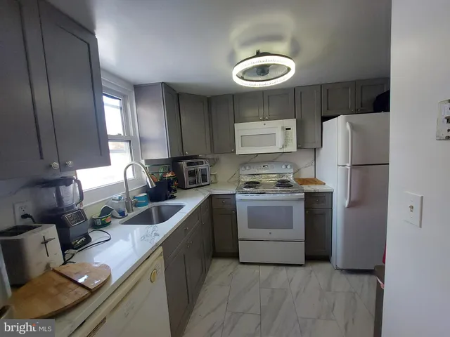 a kitchen with a refrigerator sink and stove