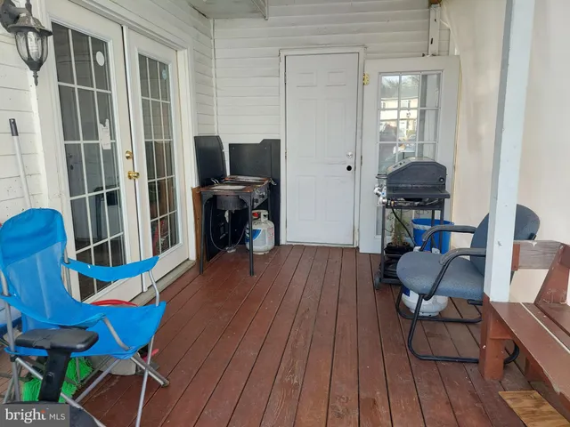 a view of a workspace with furniture and wooden floor