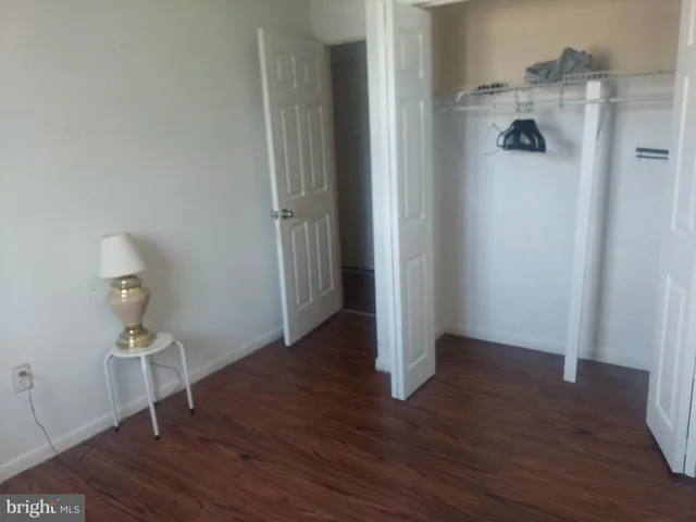 a view of a livingroom with wooden floor and sink