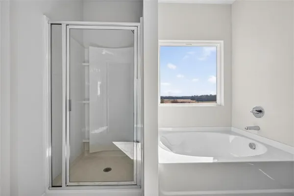 a white bath tub sitting next to a shower
