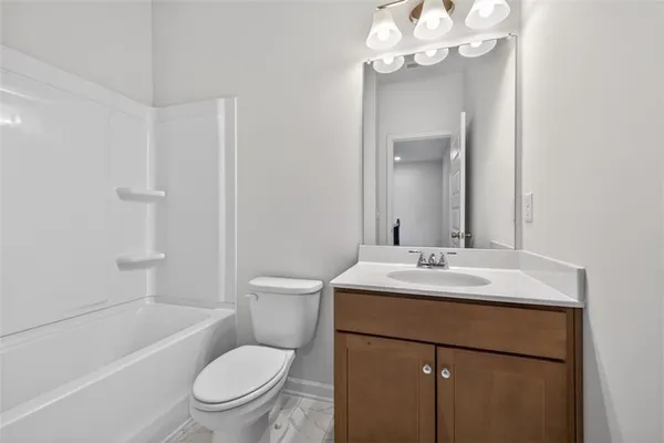 a bathroom with a toilet a sink and a bathtub
