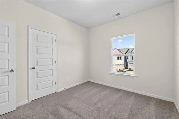 an empty room with windows and closet